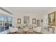 Bright living room features stylish decor, neutral colors, and large windows, seamlessly connecting indoor and outdoor spaces at 854 Blue Crane Dr, Venice, FL 34285