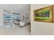 Bright living room with large windows offering a view of the outdoor pool and patio, featuring tile floors at 854 Blue Crane Dr, Venice, FL 34285