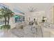 Spacious open-concept living area with modern decor, access to outdoor patio, and an eat-in kitchen at 854 Blue Crane Dr, Venice, FL 34285