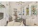Inviting sitting room featuring custom built-ins, hardwood flooring, and ample natural light at 854 Blue Crane Dr, Venice, FL 34285