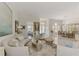 Open-concept living space with tile floors, stylish seating, and a clear view into the adjacent dining room at 854 Blue Crane Dr, Venice, FL 34285