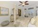 Elegant main bedroom with a four-poster bed and dresser, with pool view through sliding door at 854 Blue Crane Dr, Venice, FL 34285