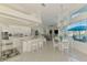 Bright, open-concept kitchen and dining area with modern appliances, granite countertops, and a clear view of the outdoor patio at 854 Blue Crane Dr, Venice, FL 34285