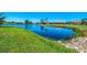 A serene pond reflecting the surrounding homes and lush greenery, creating a picturesque community landscape at 854 Blue Crane Dr, Venice, FL 34285