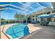 Inviting private pool area features screened enclosure and golf course view at 854 Blue Crane Dr, Venice, FL 34285