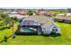 An overview of a backyard with a screened-in pool and lush landscaping at 854 Blue Crane Dr, Venice, FL 34285