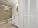Bathroom with tiled shower, a vanity with updated fixtures, and natural light at 930 Capri Isles Blvd # 120, Venice, FL 34292