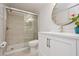 Bathroom with a glass shower, vanity, and round mirror at 930 Capri Isles Blvd # 120, Venice, FL 34292