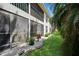 Exterior view of the home with screened in lanai and lush landscaping at 930 Capri Isles Blvd # 120, Venice, FL 34292