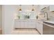 Open kitchen with stone countertops, stainless steel appliances, and modern pendant lighting at 930 Capri Isles Blvd # 120, Venice, FL 34292