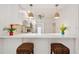 Stylish kitchen featuring modern pendant lighting, breakfast bar, and stainless steel appliances at 930 Capri Isles Blvd # 120, Venice, FL 34292