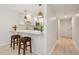 Bright kitchen with white cabinetry, bar seating, and pendant lighting at 930 Capri Isles Blvd # 120, Venice, FL 34292