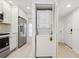 Convenient in-unit stacked washer and dryer, adjacent to a modern kitchen at 930 Capri Isles Blvd # 120, Venice, FL 34292