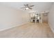 Bright living room with wood-look floors and a modern light fixture above the kitchen bar at 930 Capri Isles Blvd # 120, Venice, FL 34292