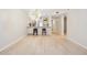 Open-concept living area featuring light wood floors and modern lighting at 930 Capri Isles Blvd # 120, Venice, FL 34292
