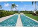 Active shuffleboard court in a well maintained community with lush landscaping and a manicured lawn at 930 Capri Isles Blvd # 120, Venice, FL 34292