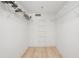 Walk-in closet featuring wood-look flooring and wire shelving at 930 Capri Isles Blvd # 120, Venice, FL 34292