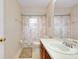 Bathroom featuring vanity with a white countertop and wood cabinetry, a toilet, and a shower with a curtain at 990 Sea Fox Rd, Venice, FL 34293