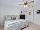 Bedroom with ceiling fan, window, and comfortable bedding at 990 Sea Fox Rd, Venice, FL 34293