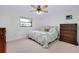 Cozy bedroom with ceiling fan, window, and decorative furniture at 990 Sea Fox Rd, Venice, FL 34293