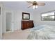 Bright bedroom featuring a comfortable bed, dresser, and natural light at 990 Sea Fox Rd, Venice, FL 34293