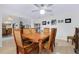 Inviting dining area featuring a ceiling fan and an adjacent living area, perfect for entertaining and comfortable living at 990 Sea Fox Rd, Venice, FL 34293