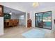 Open-concept dining area featuring a view to an enclosed sunroom and a view of the adjacent living room at 990 Sea Fox Rd, Venice, FL 34293