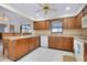Spacious kitchen features wood cabinets, stainless steel appliances, and an island with seating at 990 Sea Fox Rd, Venice, FL 34293