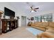 Spacious living room with light wood floors, a vaulted ceiling, and a large decorative display shelf at 990 Sea Fox Rd, Venice, FL 34293