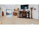 Open living room featuring light wood floors, modern lighting, and a decorative bookcase at 990 Sea Fox Rd, Venice, FL 34293