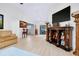 Spacious living room featuring wood flooring, modern lighting, and an adjacent dining area at 990 Sea Fox Rd, Venice, FL 34293
