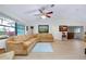 Inviting living room with vaulted ceilings, light wood floors, and a comfortable sectional sofa at 990 Sea Fox Rd, Venice, FL 34293