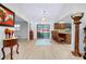 Bright living area featuring wood floors, a decorative rug, and access to a sunroom for seamless indoor-outdoor living at 990 Sea Fox Rd, Venice, FL 34293