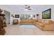 Bright living room with light wood floors, a sectional sofa, and decorative furnishings at 990 Sea Fox Rd, Venice, FL 34293