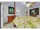 The primary bedroom features a four-poster bed, a ceiling fan, and artwork at 990 Sea Fox Rd, Venice, FL 34293