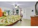 The primary bedroom features a four-poster bed, a ceiling fan, and access to the lanai at 990 Sea Fox Rd, Venice, FL 34293