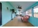Spacious sunroom with multiple ceiling fans, bright walls, and wicker furniture at 990 Sea Fox Rd, Venice, FL 34293