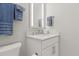 A powder room featuring a mirror with integrated lighting and a white vanity cabinet at 10136 Coral Shore Dr, Englewood, FL 34223