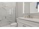Modern bathroom featuring glass enclosed shower with marble tiling and vanity with sink at 10136 Coral Shore Dr, Englewood, FL 34223