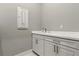 Bathroom featuring a sink, white cabinetry, and white countertop at 10136 Coral Shore Dr, Englewood, FL 34223