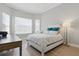 Cozy bedroom with bay windows, hardwood flooring and a comfortable looking bed at 10136 Coral Shore Dr, Englewood, FL 34223
