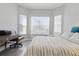 Bedroom with desk and chair, bay windows and hardwood flooring at 10136 Coral Shore Dr, Englewood, FL 34223