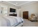 Well appointed bedroom with flat screen television, bedside seating and an ensuite bath at 10136 Coral Shore Dr, Englewood, FL 34223