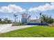 Exterior shot of the Beachwalk by Manasota Key community entrance with blue accents and landscaping at 10136 Coral Shore Dr, Englewood, FL 34223