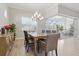 Dining area with sliding glass doors leading to the screened-in lanai, offering indoor-outdoor living at 10136 Coral Shore Dr, Englewood, FL 34223