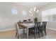 Bright dining room features a modern chandelier, natural light, and stylish furnishings at 10136 Coral Shore Dr, Englewood, FL 34223