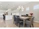 Elegant dining area adjacent to the kitchen, features a chandelier and modern decor at 10136 Coral Shore Dr, Englewood, FL 34223
