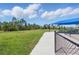 Dog park features a grassy area and a covered seating area for dog owners to relax at 10136 Coral Shore Dr, Englewood, FL 34223