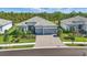 Beautiful single-story home featuring a tile roof, well-manicured landscaping, and a spacious brick driveway at 10136 Coral Shore Dr, Englewood, FL 34223