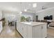 Bright kitchen with stainless steel appliances, large center island, and open layout to the dining area at 10136 Coral Shore Dr, Englewood, FL 34223
